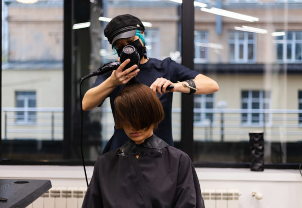 professional-girl-hairdresser-makes-client-haircut-the-girl-is-sitting-in-mask-in-beauty-the-salon-1-scaled.jpg